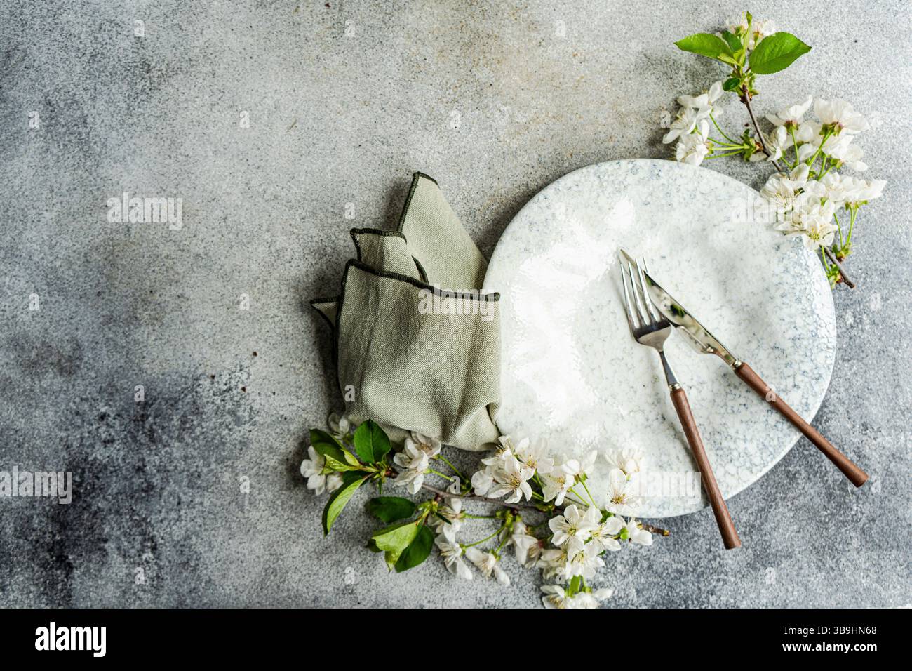 Spring table setting with cherry blossoms Stock Photo