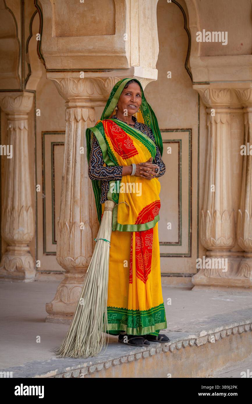 Colourfully dressed, Indian female sweeper at Amber Fort, Amer Stock Photo
