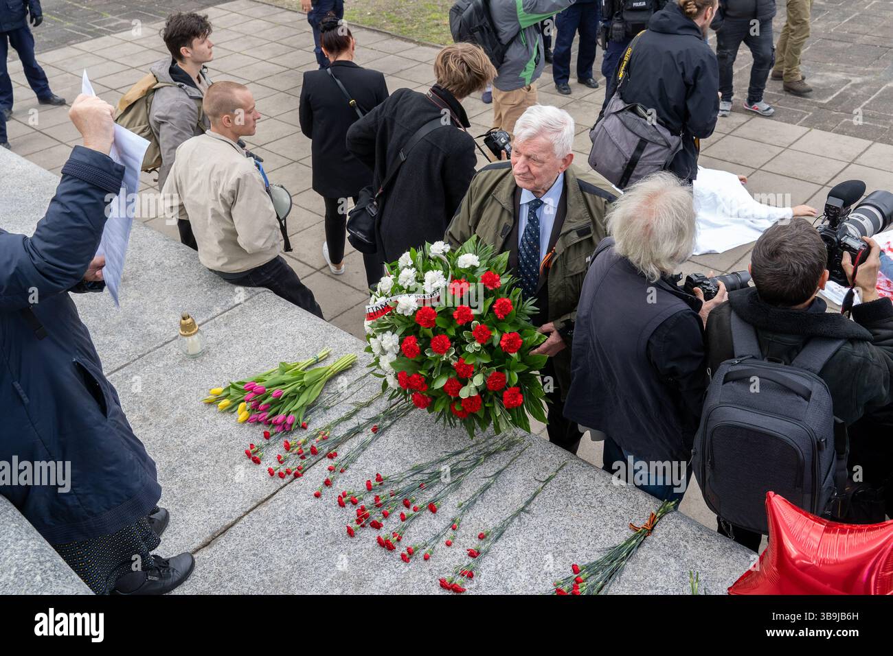 A man lays flowers at the Soviet military cemetery during the 80th ...