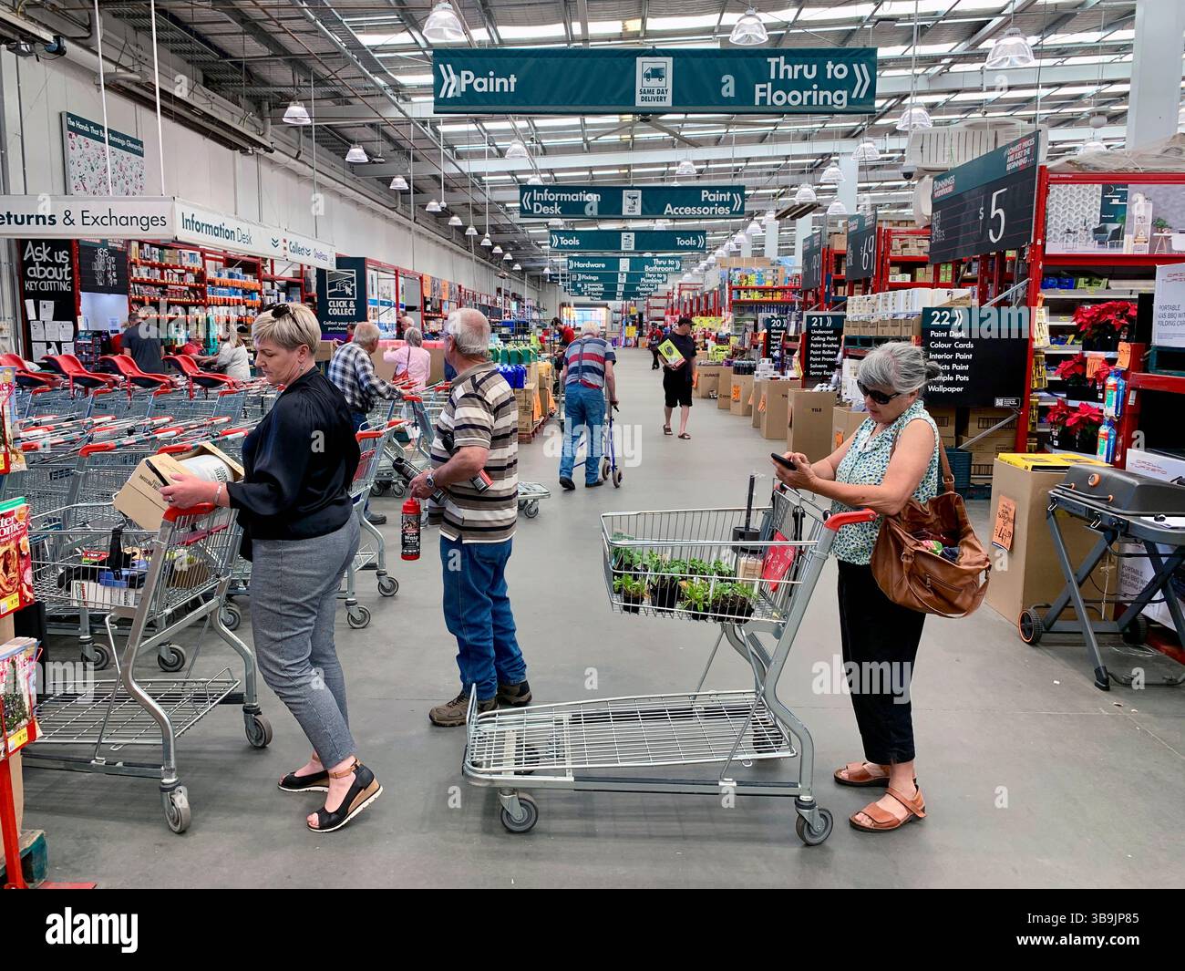Store Queueing Customers queuing at the checkout in Bunnings Harware store in ...