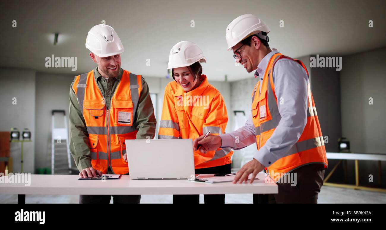 Professional Engineers Examine House Blueprint With Young Couple Looking On. Builders, Engineers Stock Photo