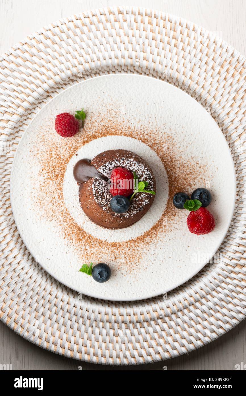 Beautiful chocolate lava cake coulant from a top view with christmas decorations. Stock Photo