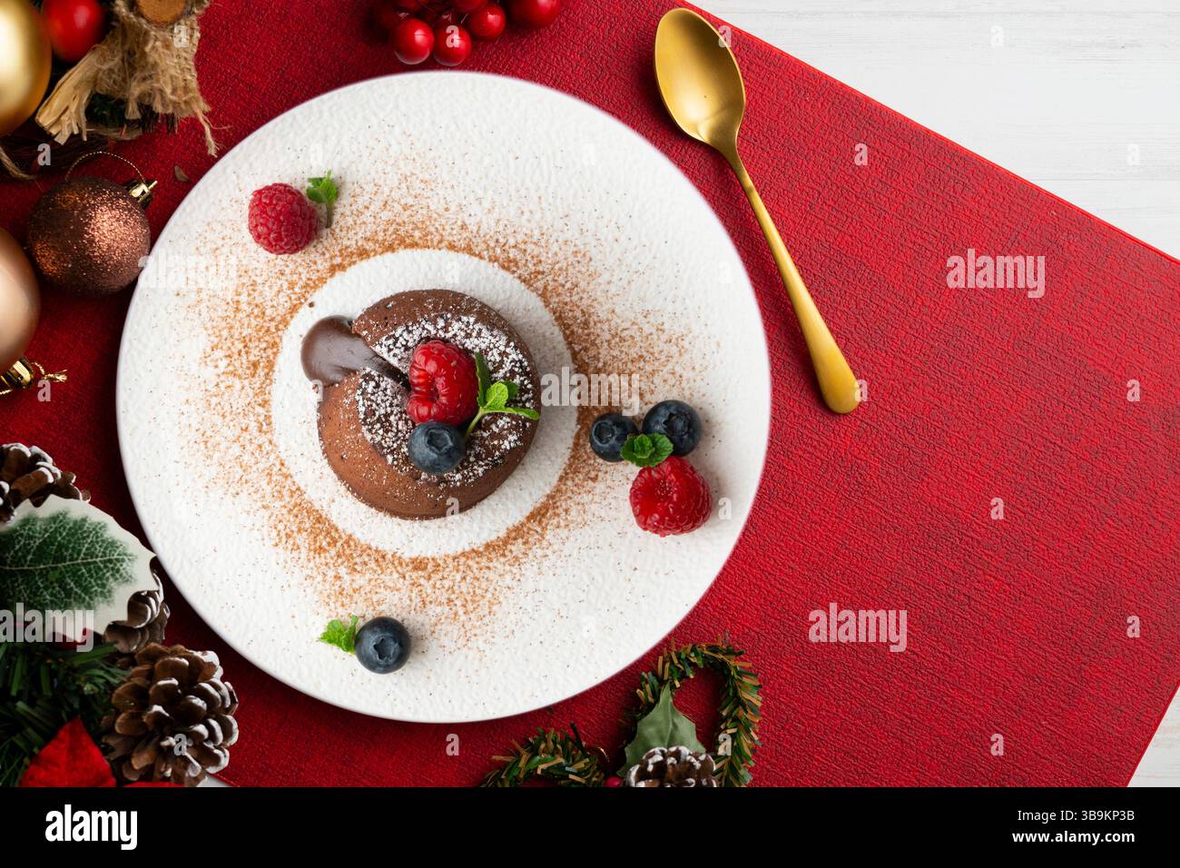 Beautiful chocolate lava cake coulant from a top view with christmas decorations. Stock Photo