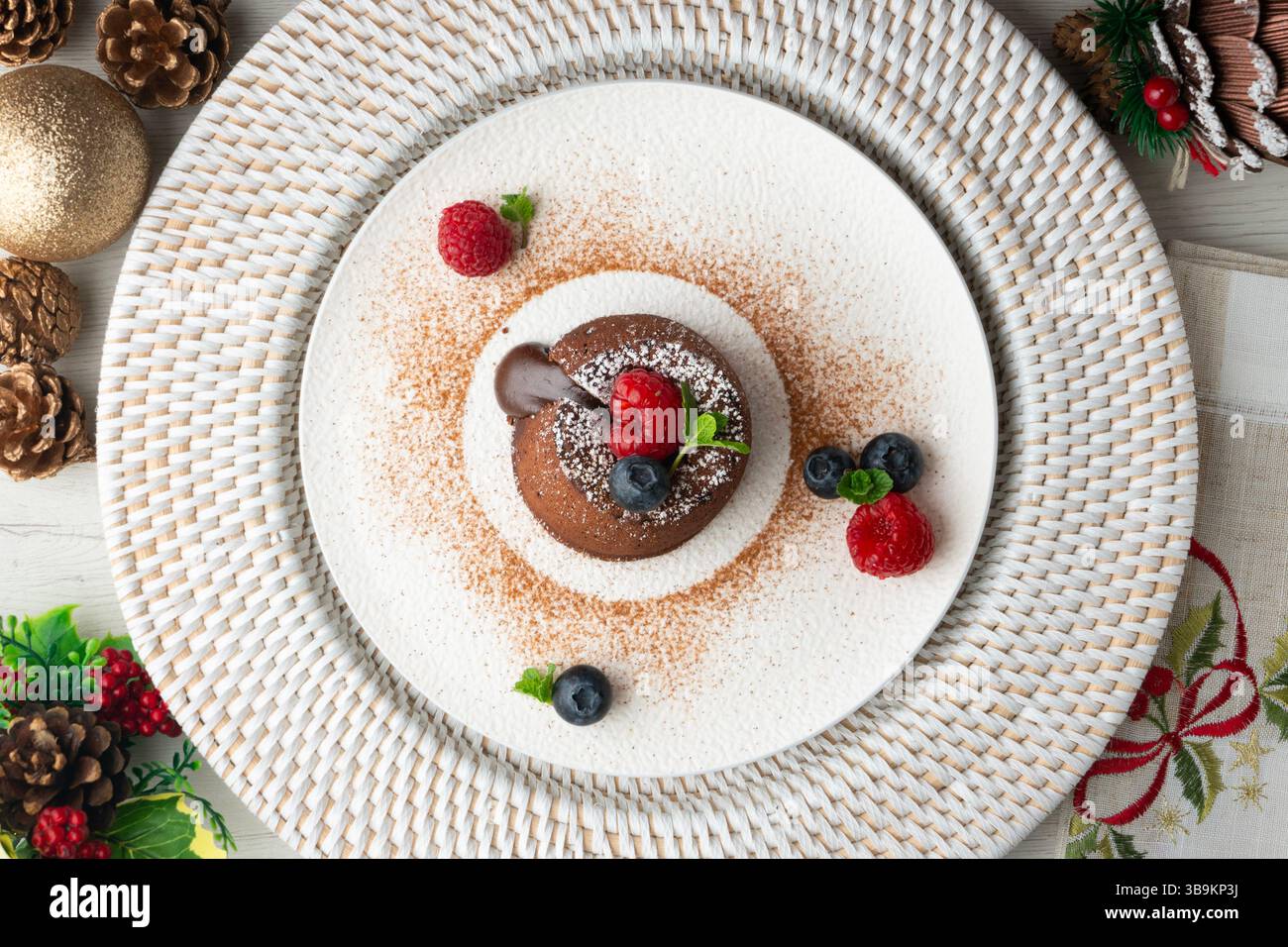 Beautiful chocolate lava cake coulant from a top view with christmas decorations. Stock Photo