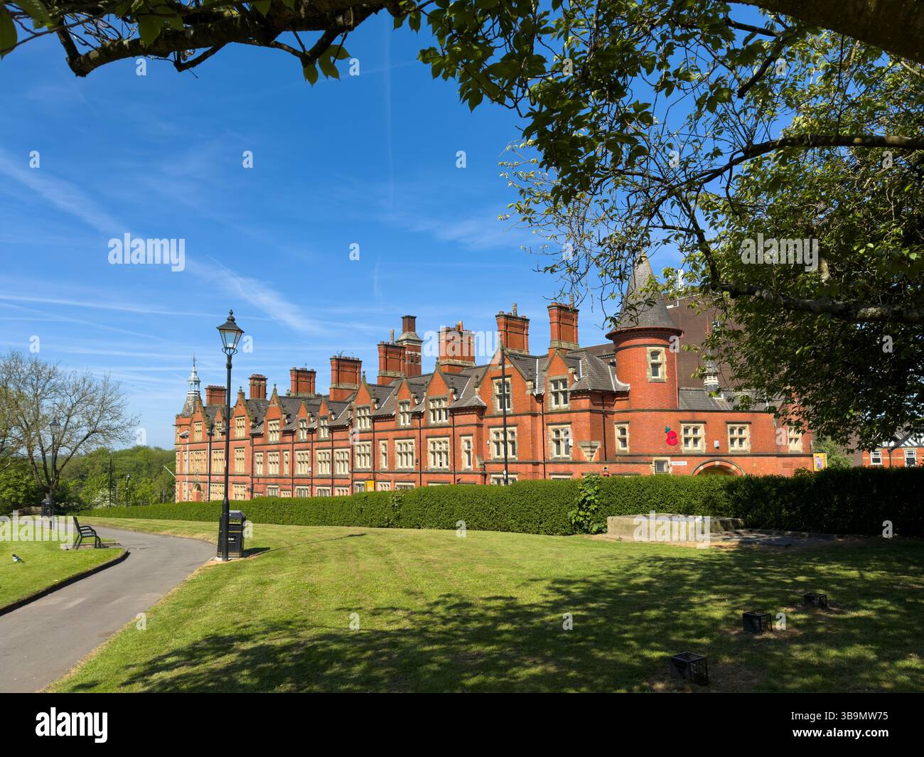 Row of red brick buildings on Crawford Street. , Wigan from gardens of parish church - Smartphone Captured Stock Image