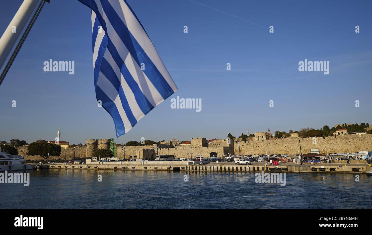 Departure of a ferry, Greek flag in front of harbour and historic city ...