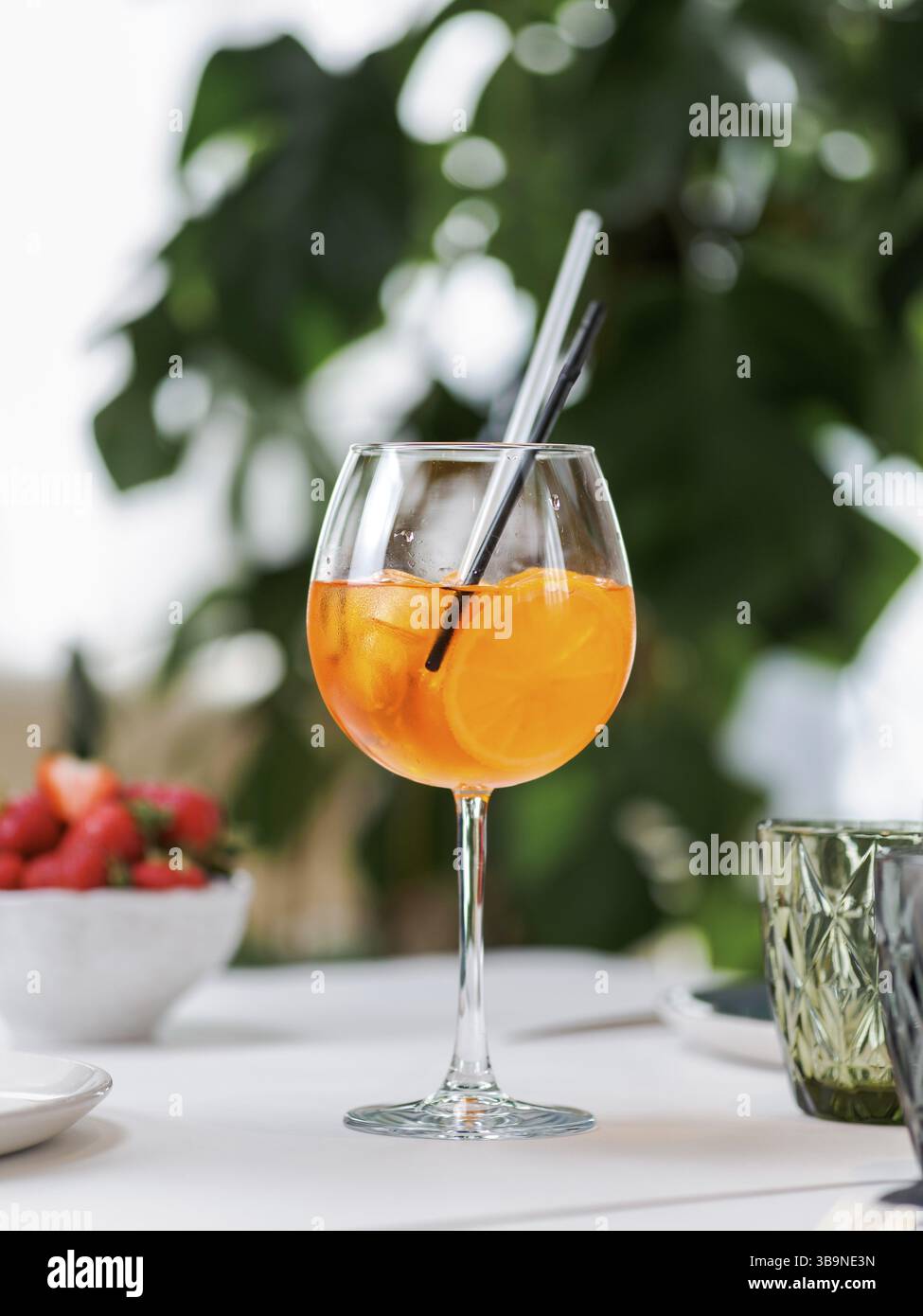 Typical summer drink Aperol Spritz aperitif served in wine glass with ...