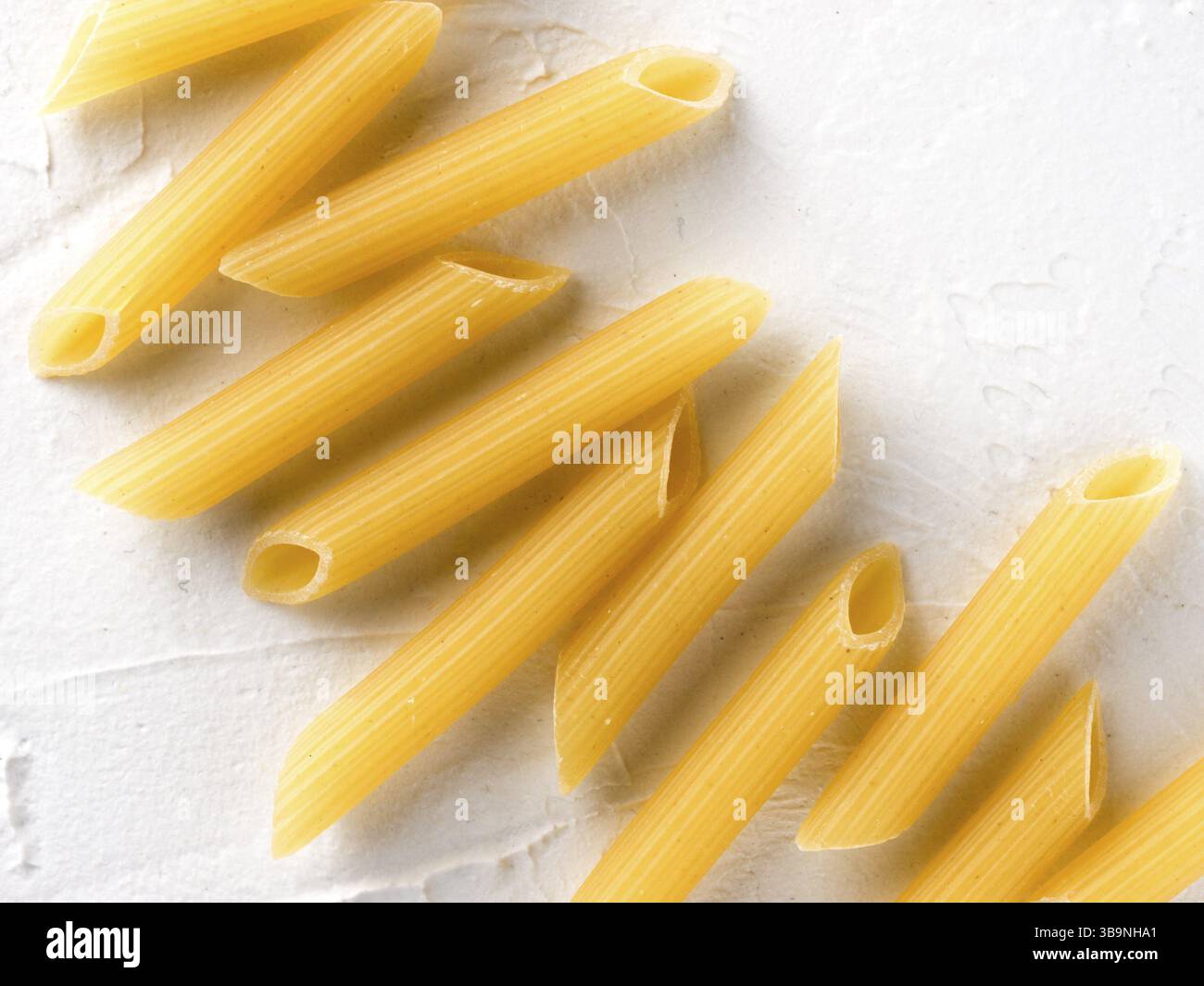 Textured Pasta Raw pasta as food background. Italian Penne Rigate Macaroni Pasta on ...