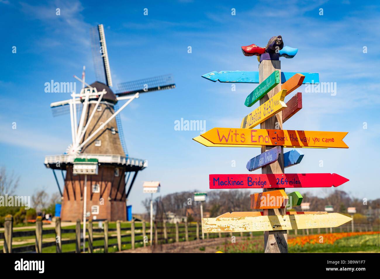 Photo of real Dutch windmill next to colorful country directions sign ...