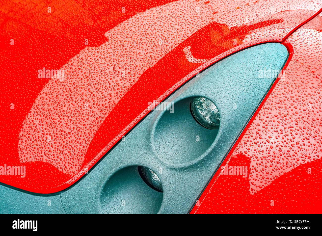 Headlight cluster on a 2002-2005 red and silver Smart Roadster sports car - Preuilly-sur-Claise, Indre-et-Loire (37), France. Stock Photo