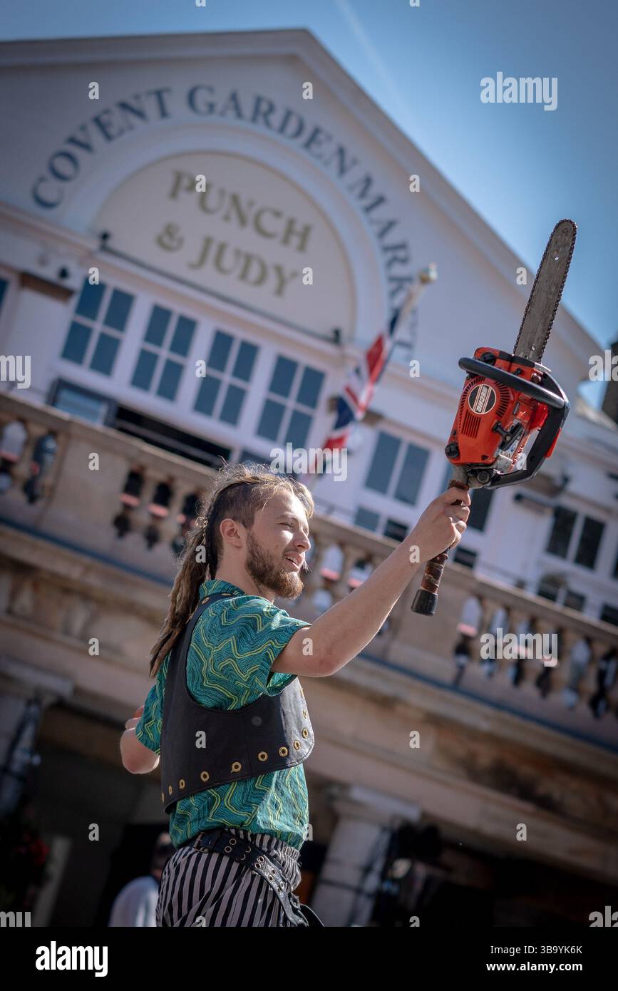 London, UK. 11th May 2025. Covent Garden Piazza celebrates 50 years of modern street performance with past and present performers featuring live music, dance and circus acts. Pictured: Chainsaw juggler. Credit: Guy Corbishley/Alamy Live News Stock Photo