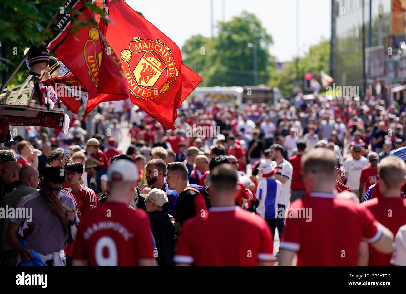 Manchester, UK. 11th May, 2025. A flag flutters over the arriving fans as they make their way t the stadium before the Manchester United vs West Ham United Premier League match at Old Trafford, Manchester. Picture credit should read: Andrew Yates/Sportimage Credit: Sportimage Ltd/Alamy Live News Stock Photo