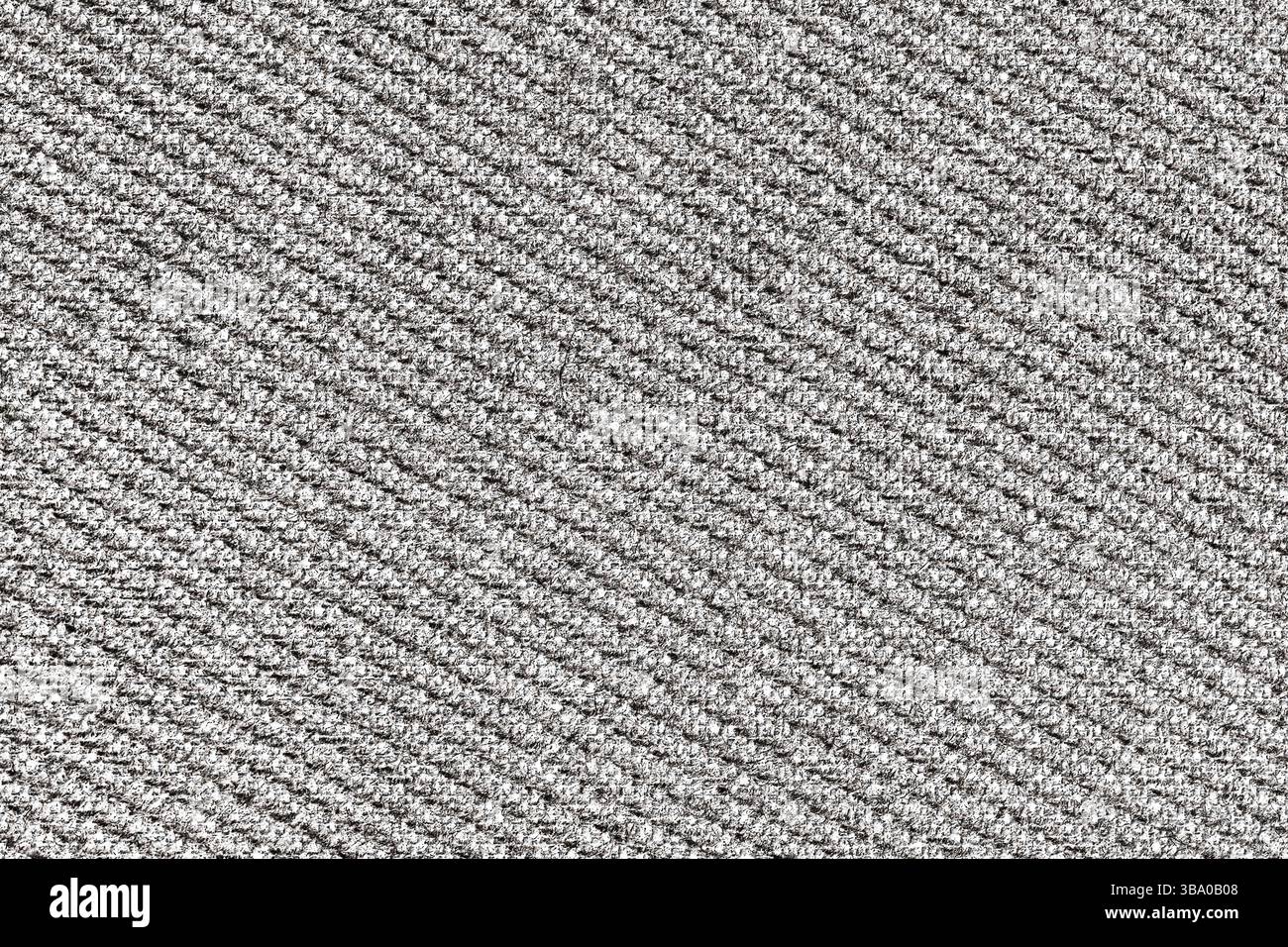 Closeup of grey fabric texture. Diagonal textile pattern. Woven material structure. Soft wool or carpet surface. Stock Photo
