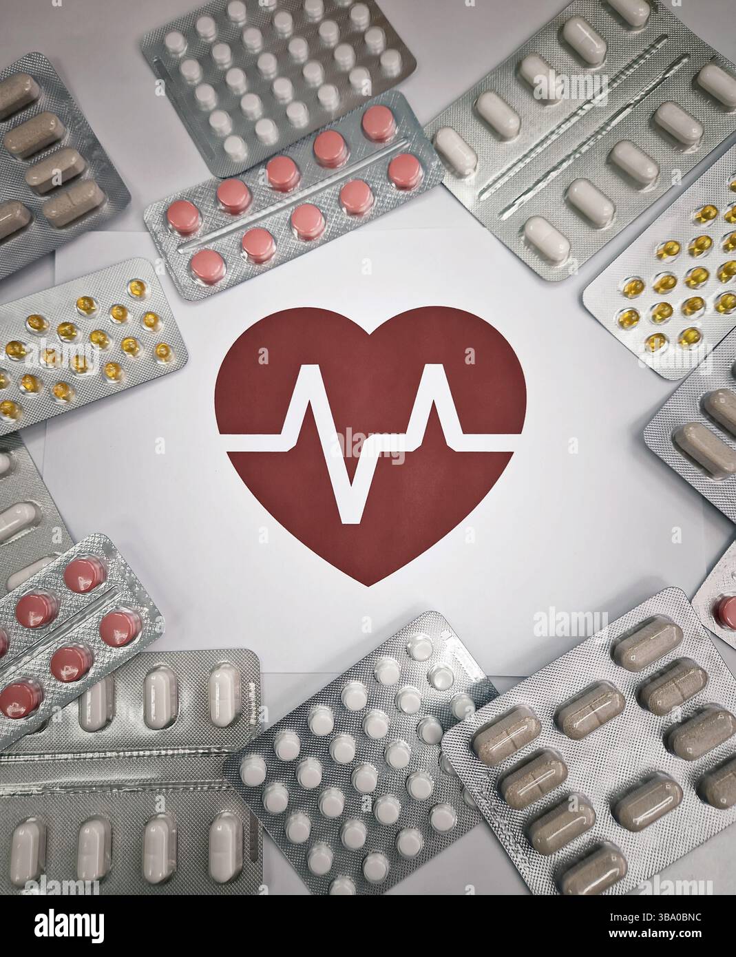 Various blister packs of pills arranged around a red heart symbol with an electrocardiogram, ECG pulse line inside. Drugs of different shapes and colo - Smartphone Captured Stock Image