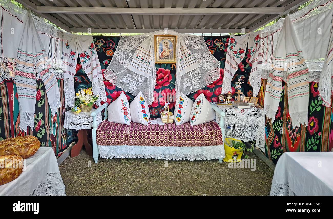 UNGHENI, MOLDOVA - MAY 04, 2025 Exposition of handmade bakery and different crafts. Traditional Moldovan festive setup with embroidered textiles and r - Smartphone Captured Stock Image