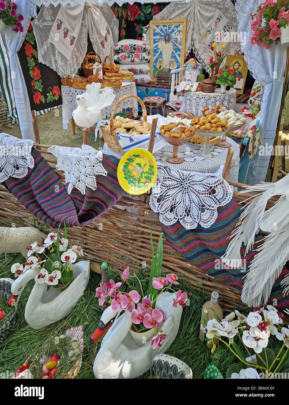UNGHENI, MOLDOVA - MAY 04, 2025 Exposition of handmade bakery and different crafts. Traditional Moldovan festive setup with embroidered textiles and r - Smartphone Captured Stock Image