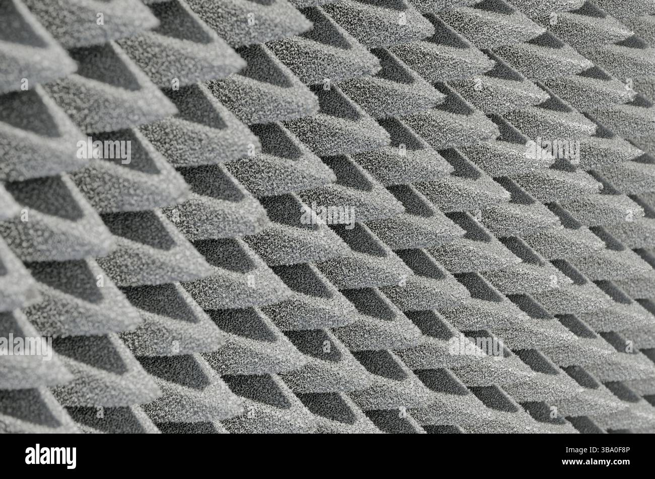 Embossed sound-absorbing panel, close up shot, abstract grey background Stock Photo