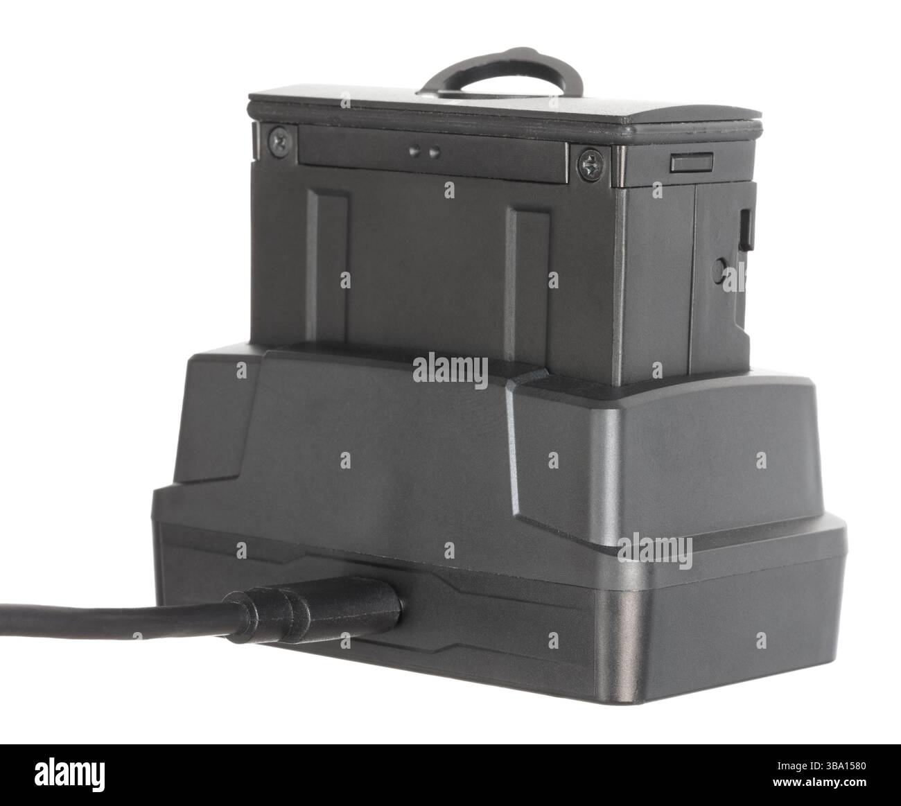 Riflescope's power source that has been taken outof the night vision optic and in the cradle for recharding isolated on a white background. Stock Photo
