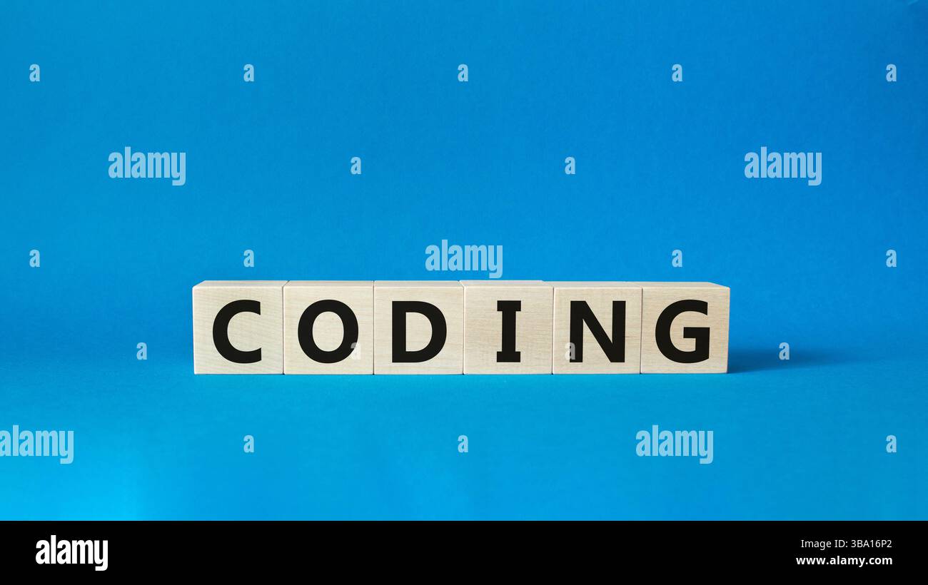Coding symbol. Concept word Coding on wooden cubes. Beautiful blue background. Business and Coding concept. Copy space. Stock Photo