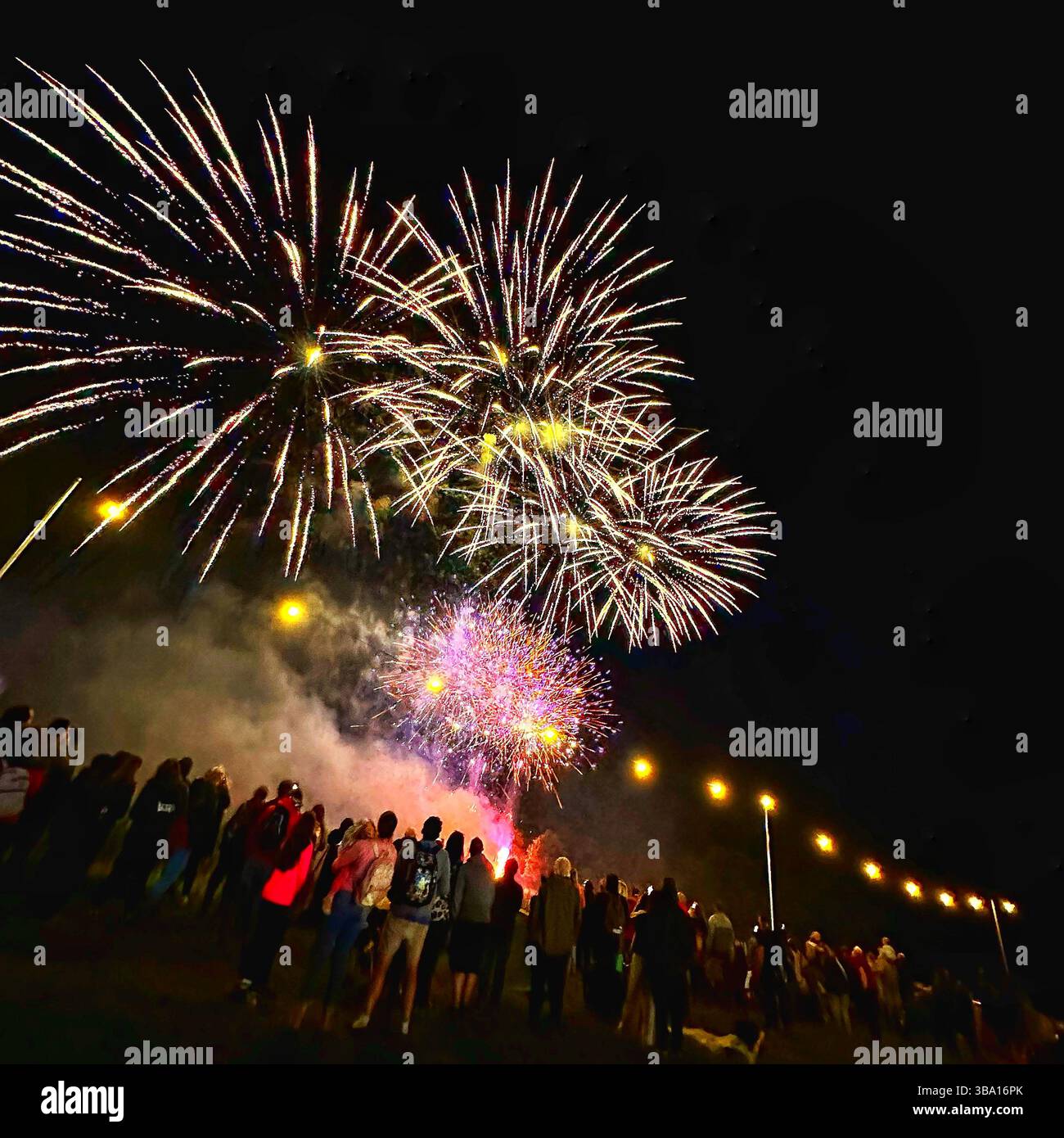 Fireworks display at Cheshire Balloon Fiesta, Bolesworth Estate, Tattenhall, UK, with crowd and festoon lights, 6 August 2023. Editorial use. - Smartphone Captured Stock Image