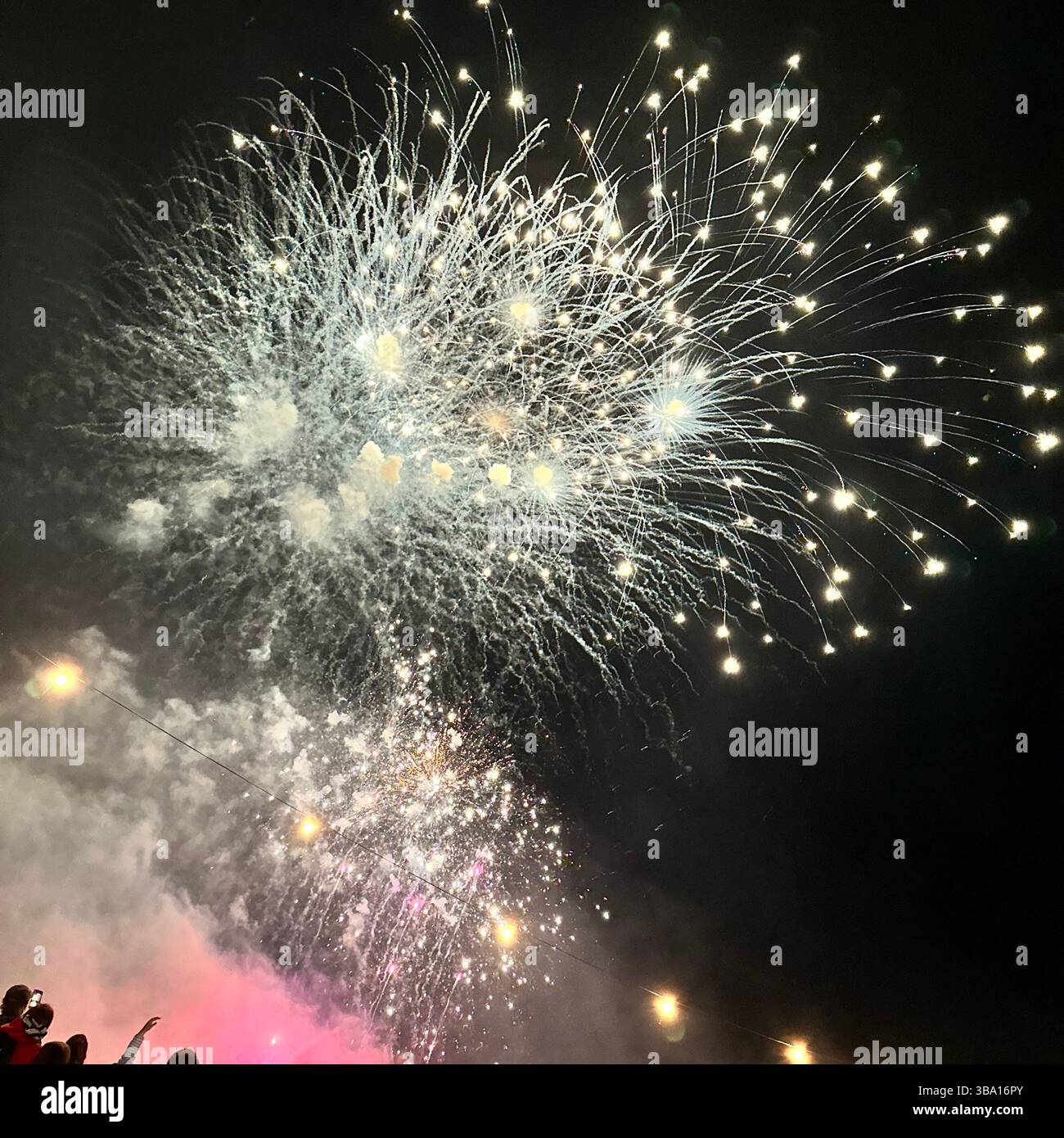 Fireworks display at Cheshire Balloon Fiesta, Bolesworth Estate, Tattenhall, UK, with crowd and festoon lights, 6 August 2023. - Smartphone Captured Stock Image