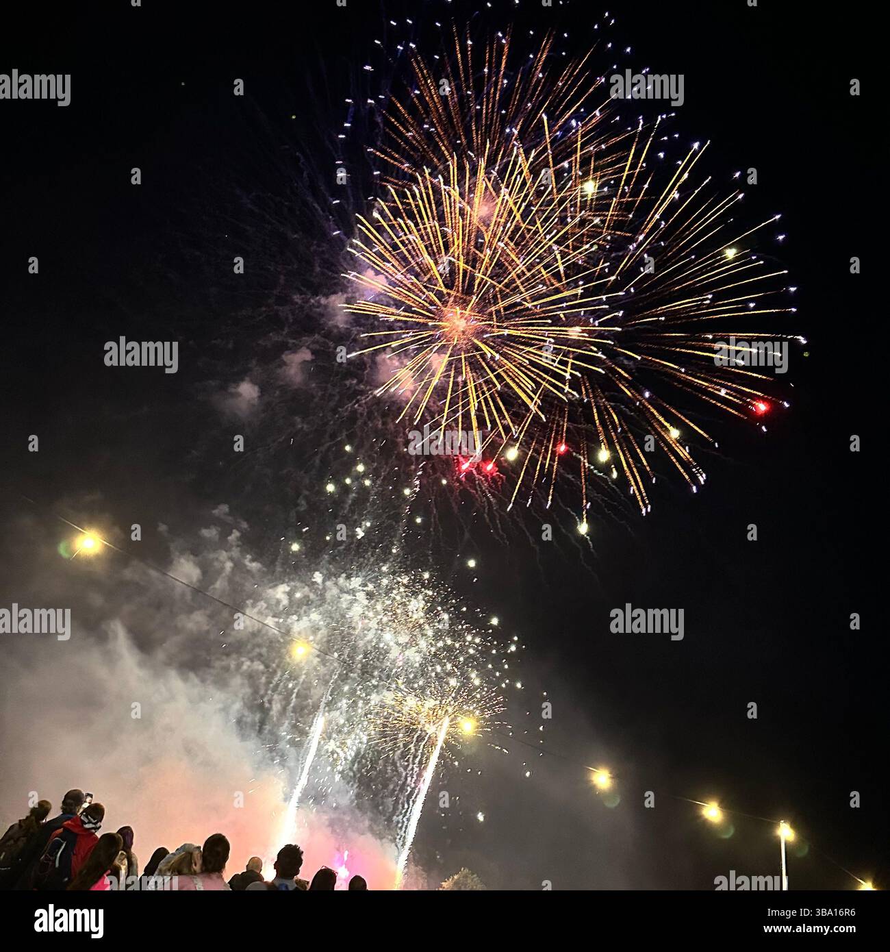 Fireworks display at Cheshire Balloon Fiesta, Bolesworth Estate, Tattenhall, UK, with crowd and festoon lights, 6 August 2023. Editorial use. - Smartphone Captured Stock Image