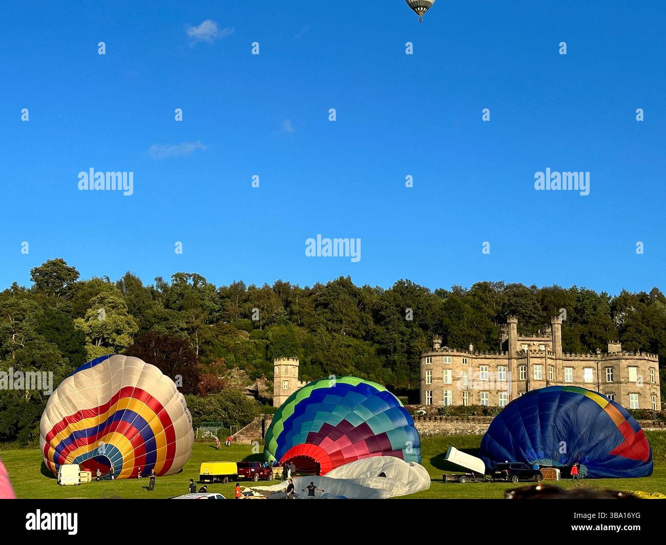Hot air balloons being prepared for flight at Cheshire Balloon Fiesta, Tattenhall Castle, Chester, Bolesworth Estate, UK, 6 August 2023. Editorial Use - Smartphone Captured Stock Image