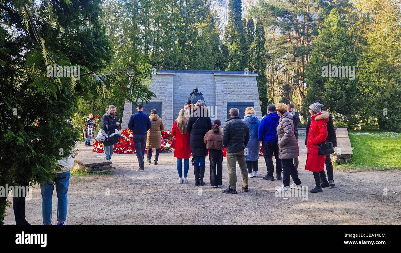 Controversial Soviet World War II war memorial in Tallinn. On May 9, many ethnic Russians in Estonia, commemorate Victory Day by bringing red flowers. - Smartphone Captured Stock Image