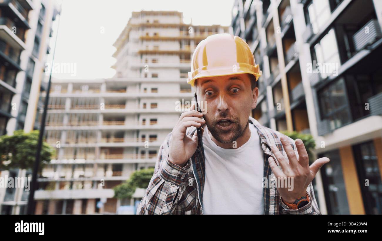 Engineer talking on phone. Architect using phone on construction site. Foreman phone call control process. Construction worker communications in const Stock Photo