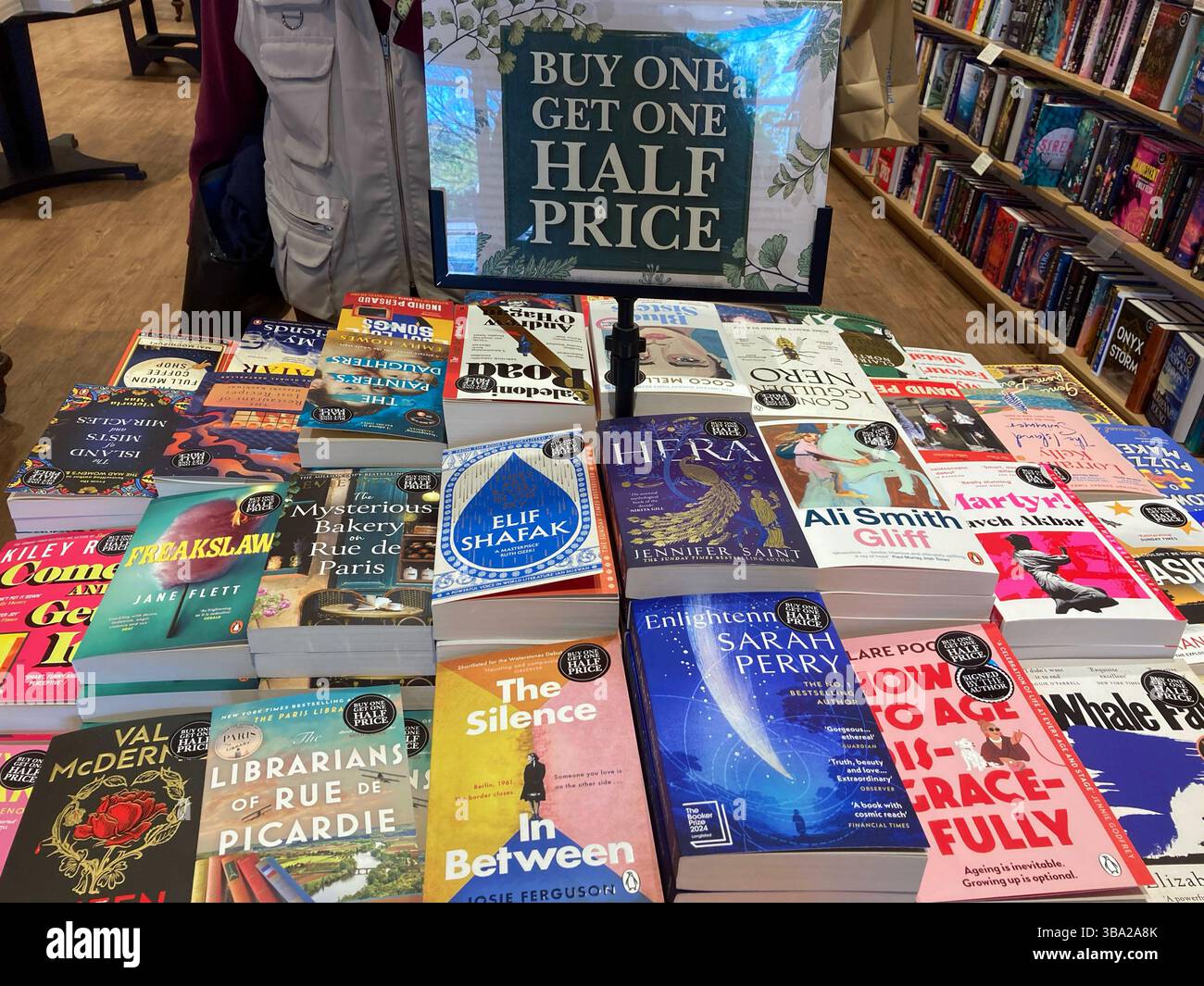 A selection of books for sale at the book store, with a buy one get one half price offer - Smartphone Captured Stock Image