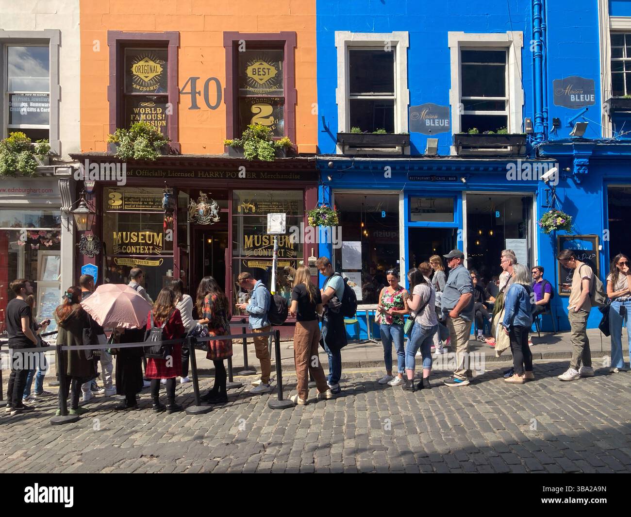 Queues awaiting entry outside the Harry Potter Museum, Victoria Street Edinburgh, Scotland - Smartphone Captured Stock Image