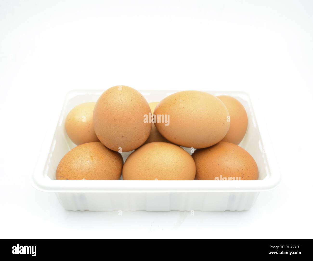 Eggs, fresh brown eggs in the white plastic box Stock Photo