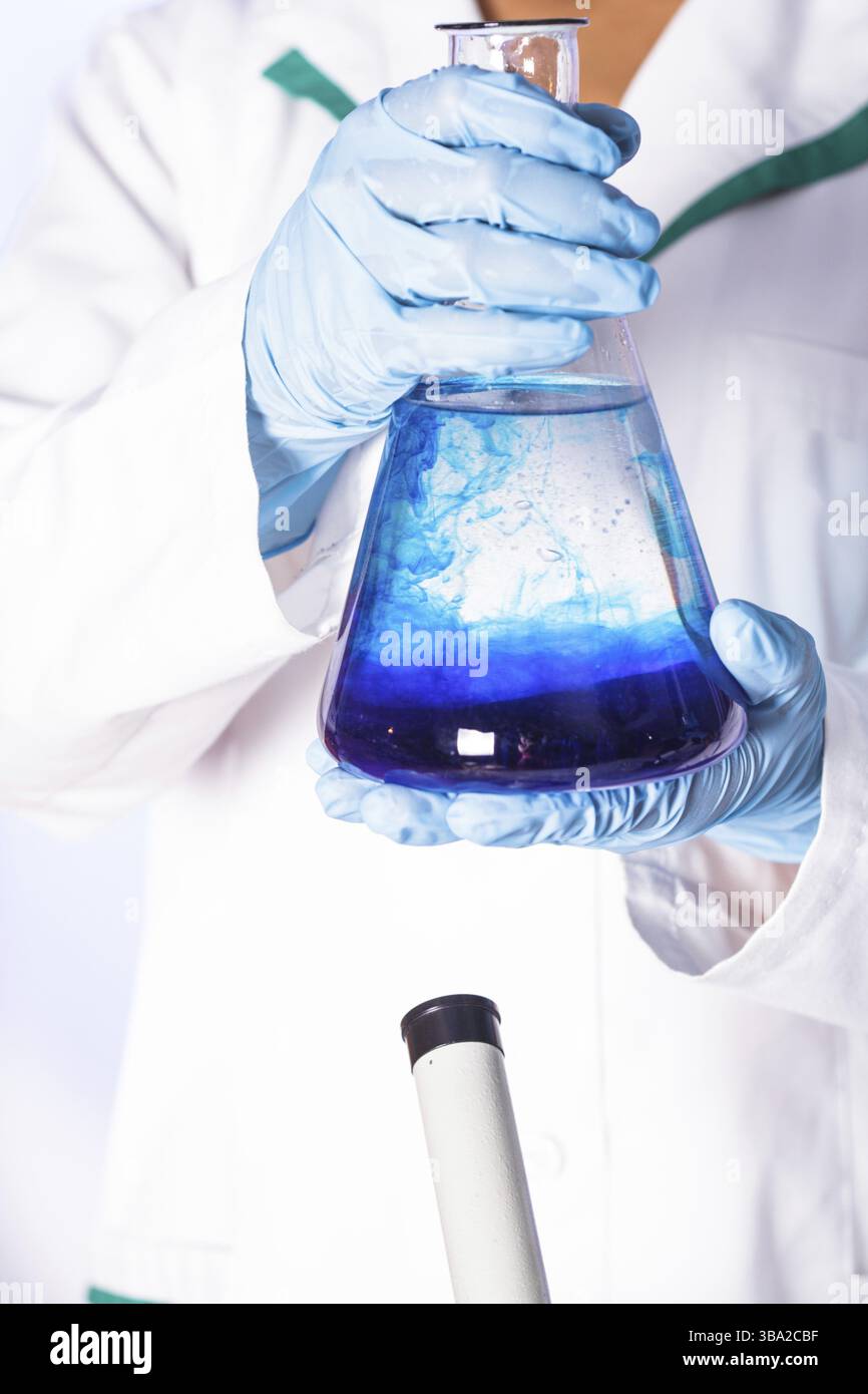 Scientist shows a diffusion in the flask Stock Photo