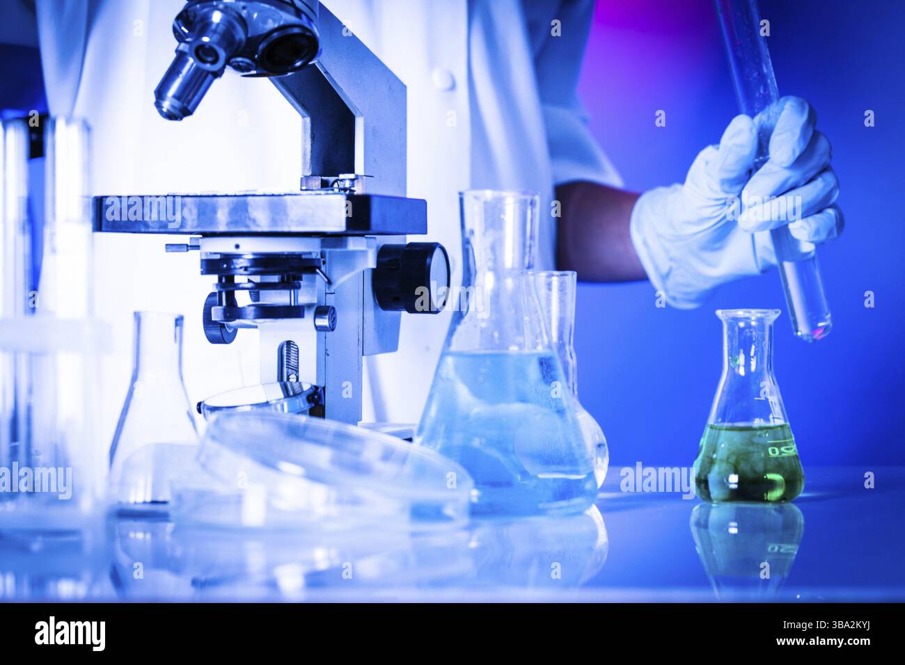 Scientist in the chemical laboratory is doing experiments Stock Photo