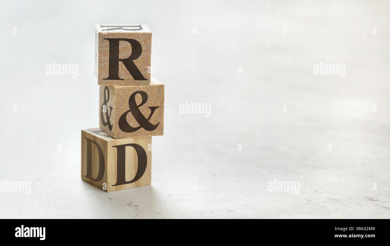 Pile with three wooden cubes - letters R&D meaning Research and Development on them, space for more text / images at right side, Liptovsky Hradok, Slo Stock Photo