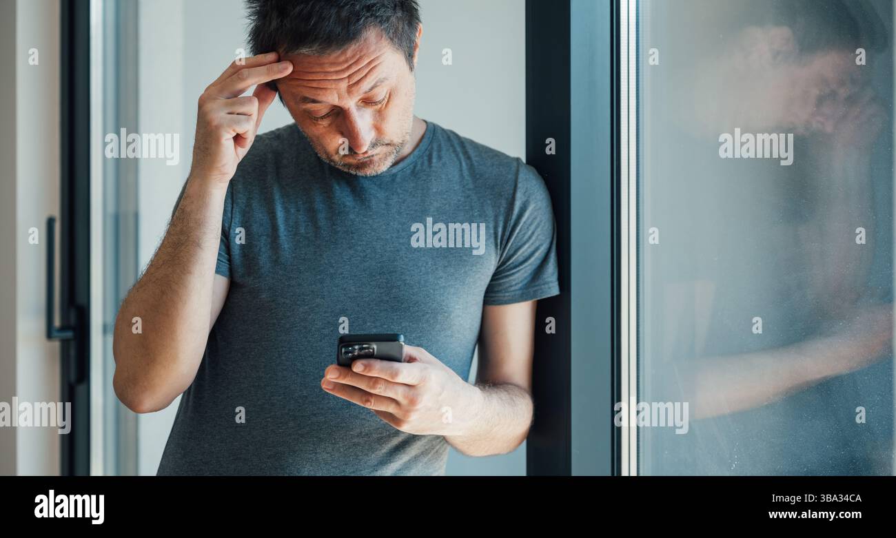 Reading worrying text message on mobile phone, selective focus Stock Photo