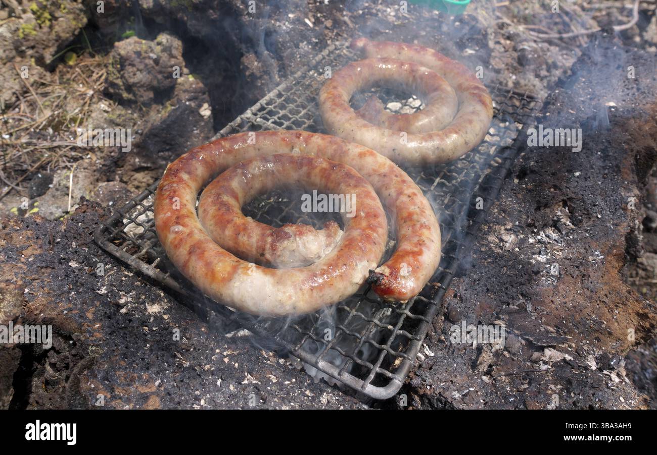 portable grill to grilling outdoors sausages in Etna Park, Sicily, Italy Stock Photo