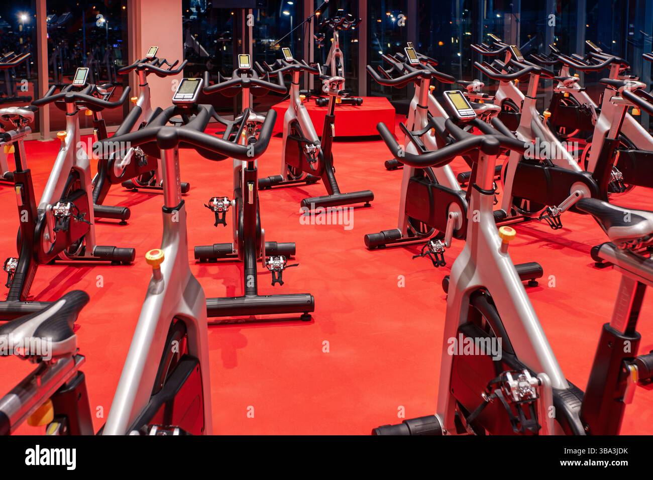 empty spinning class studio at the gym, red floor Stock Photo