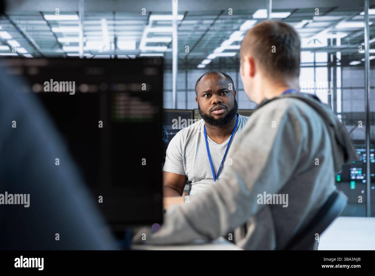Manager admonishing developer after making error damaging high tech data center. Supervisor scolding IT staff member after doing mistake in server room affecting supercomputers Stock Photo