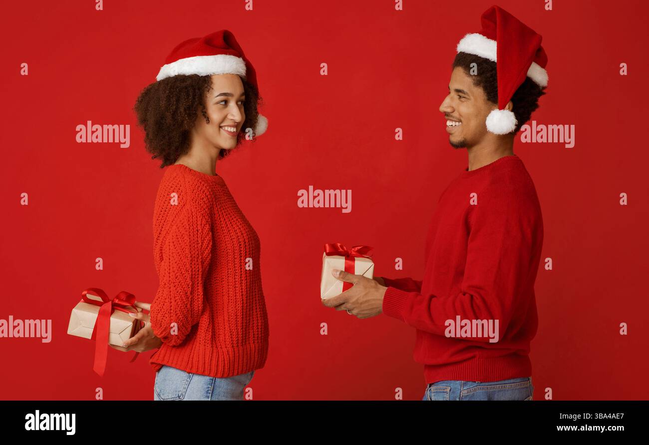 Couple in love exchanging New Year presents Stock Photo