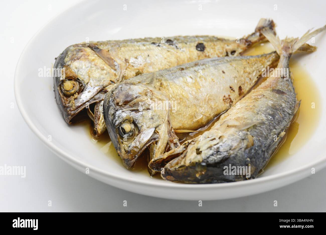 Fried mackerel on white plate. Deep fried fish Stock Photo