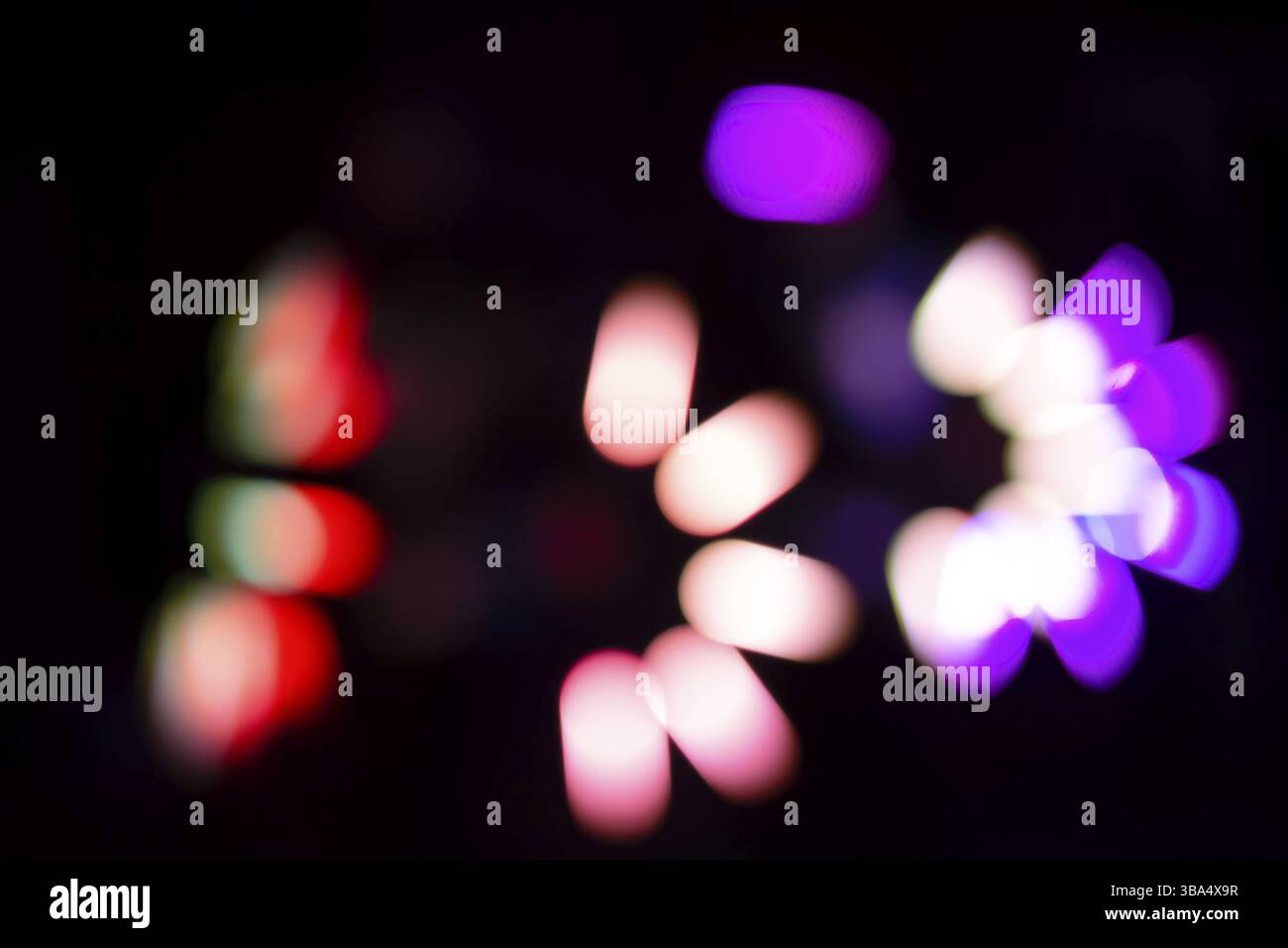 Multicolored defocused bokeh on a black background Stock Photo