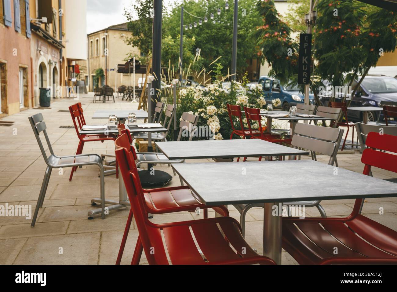 Theme cafes and restaurants. Exterior summer terrace of bright colors of street cafe shop in Europe in France. Preserved tables Without people, at tab Stock Photo