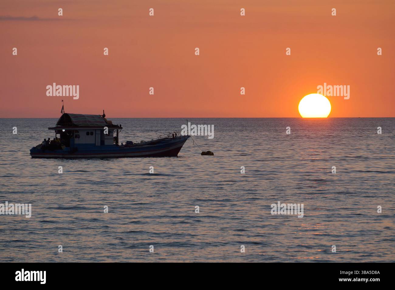Fishing boat while taking a break ahead of sunset Stock Photo - Alamy