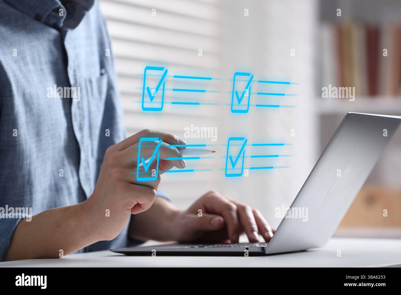 Approved. Man using laptop and touching virtual screen with check marks at table, closeup Stock Photo