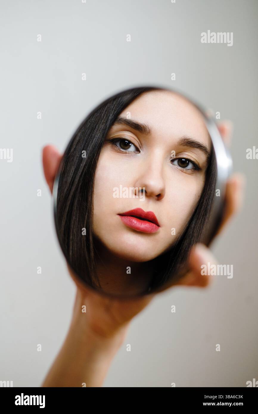 Woman's reflection in a mirror Stock Photo