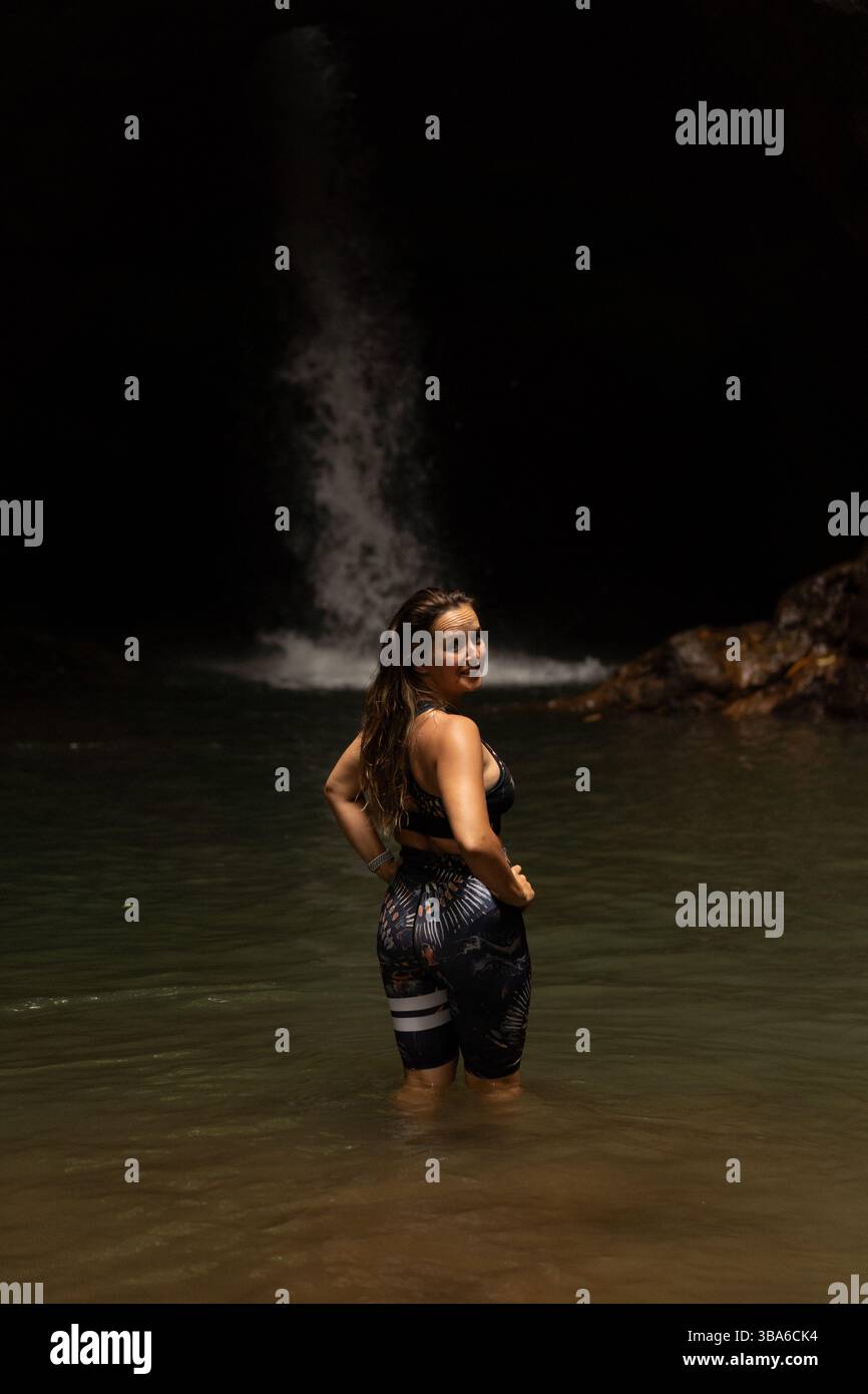 Woman in front of waterfall on the island of Bali Stock Photo - Alamy