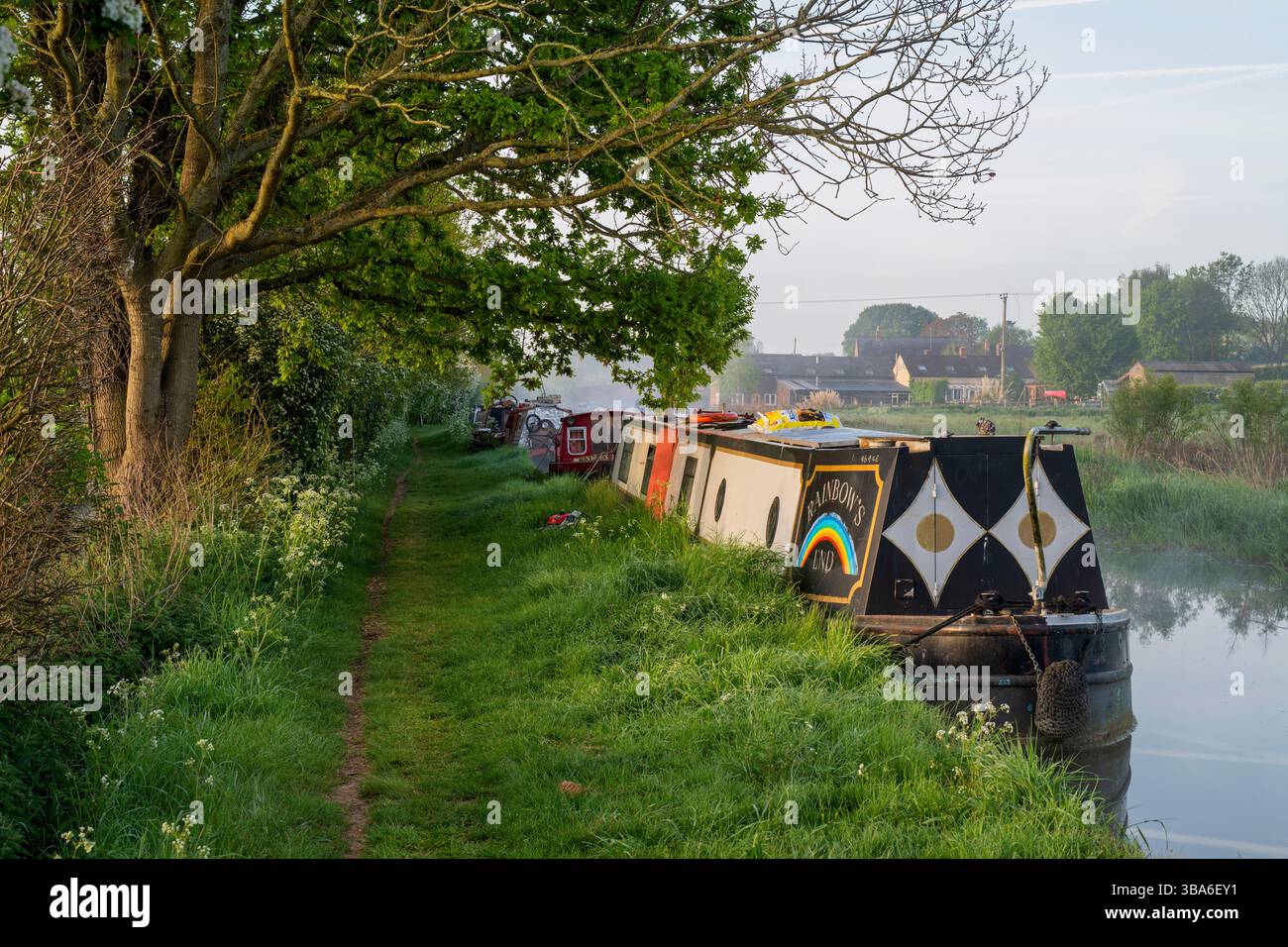 Narrowboats on the Oxford canal in spring at sunrise near Twyford wharf. Kings Sutton, Oxfordshire / Northamptonshire border, England Stock Photo