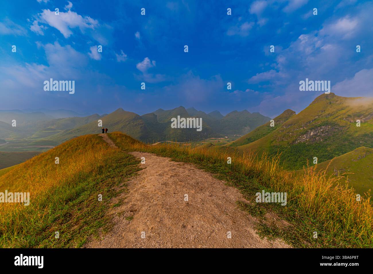 Slaveiu Ridge Remote Path A small path on the ridge, white fluffy clouds in the blue sky float ...