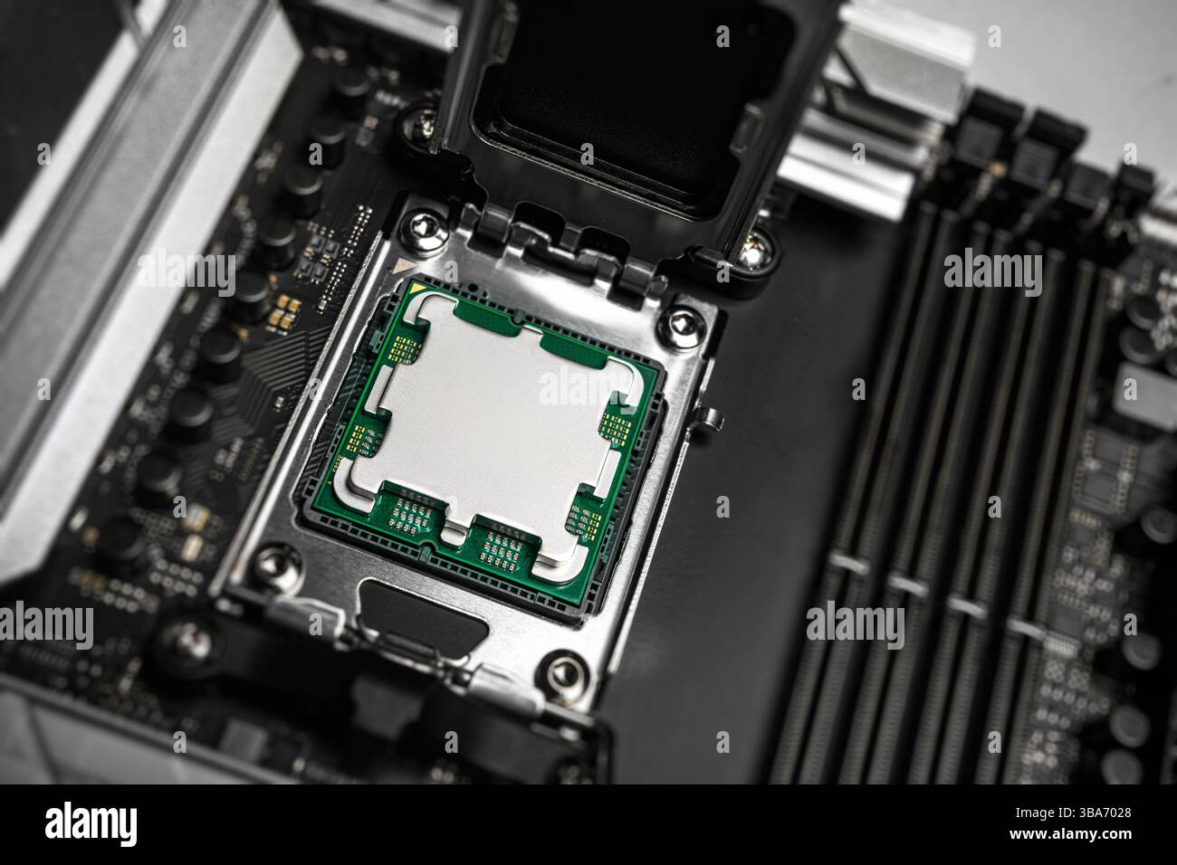 A central processing unit is securely seated in a motherboard socket Stock Photo
